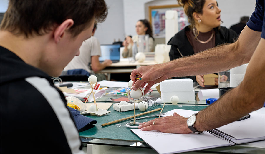 A student looking at their work in progress