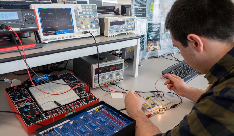 Research student testing his electronics circuit