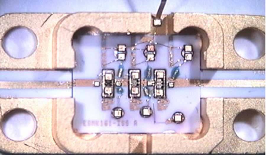 An ultra broadband amplifier (2-20GHz) showing four holes and some circuitry
