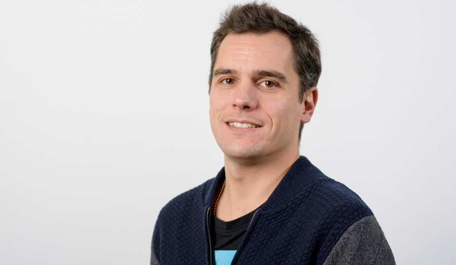 Short-haired male lecturer Bruno Sil dos Santos smiles widely to the camera.