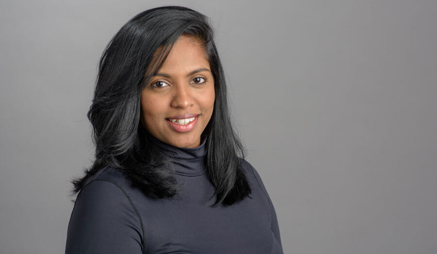 Sandra Fernando, a female lecturer with shoulder length black hair, smiles to camera.