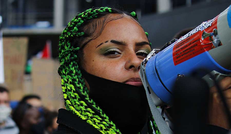 a girl with a megaphone at a black lives matter protest