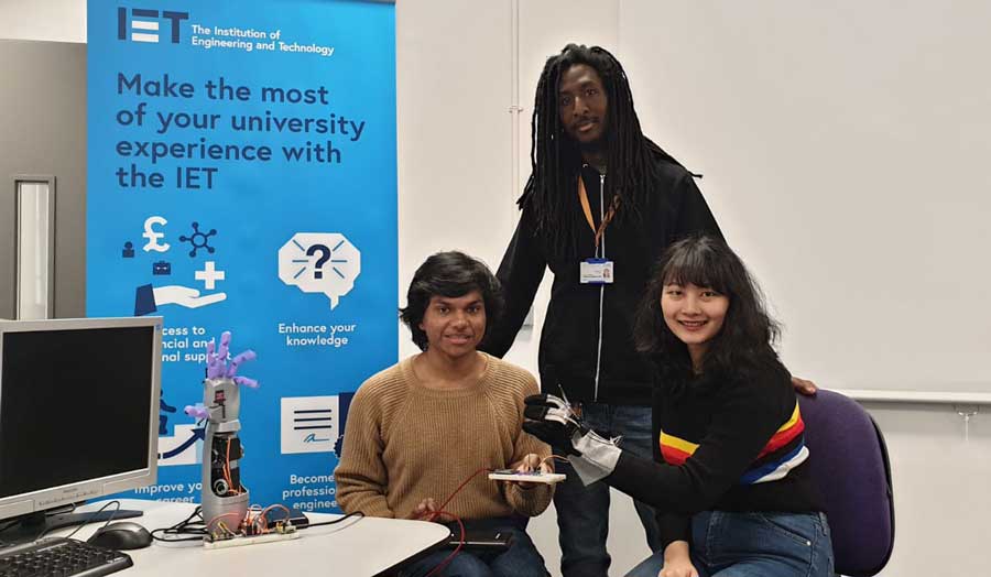 three students showing their project at a fair