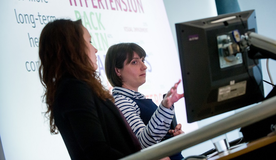 Two females giving a lecture