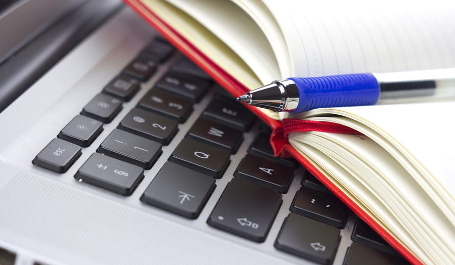 Books and a laptop and pen