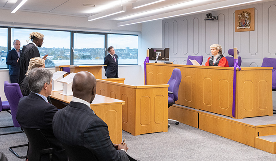 Group of people sitting in mock courtroom