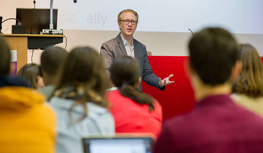 A speaker talking to students in a classroom