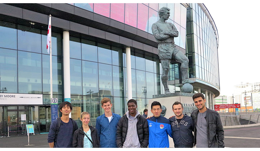 Sports Management Postgraduates by the Bobby Moore Statue at Wembley Stadium.