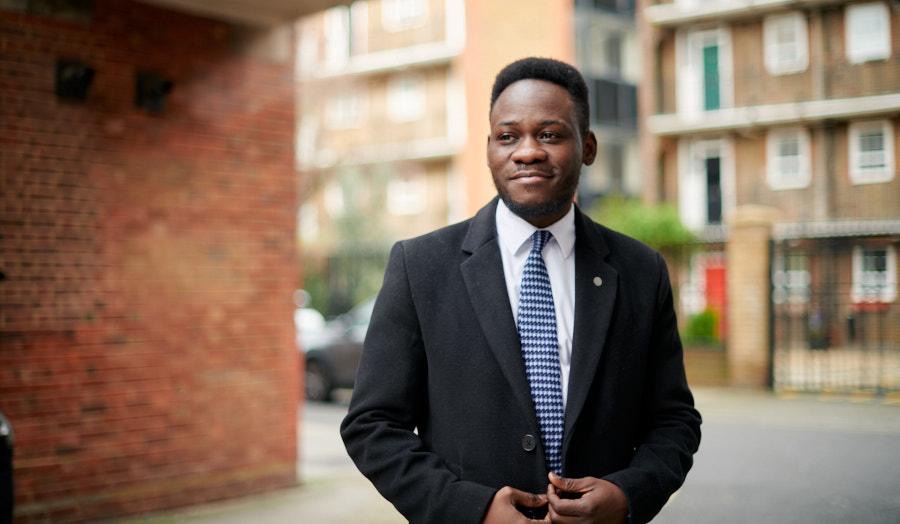 Dr Oluwaseun Ajayi headshot image with building in background