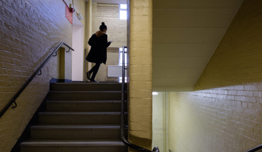 Student in yellow corridor