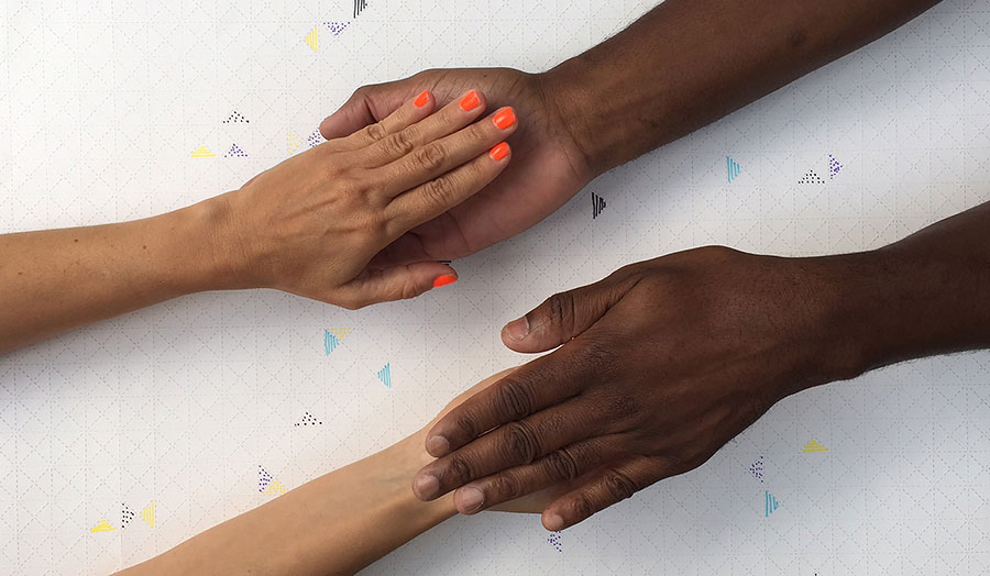 Image from Give and Take Studio of two hands touching