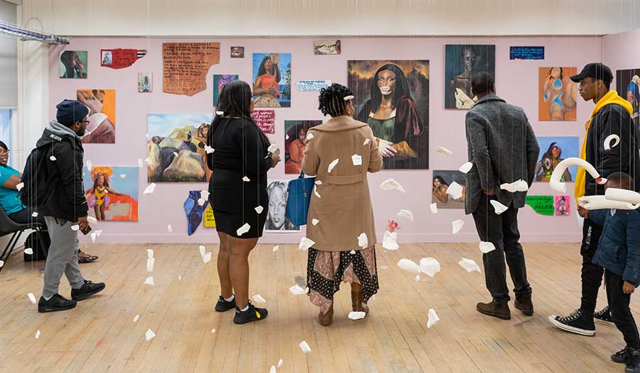 visitors viewing students' painting at The Cass summer show