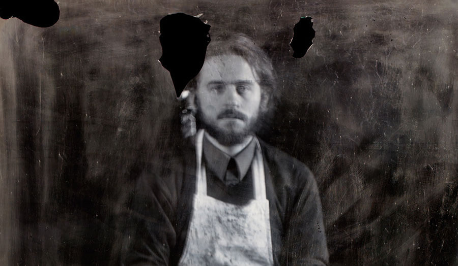 A monochromatic photograph of male bearded lecturer Sebastian Edge.