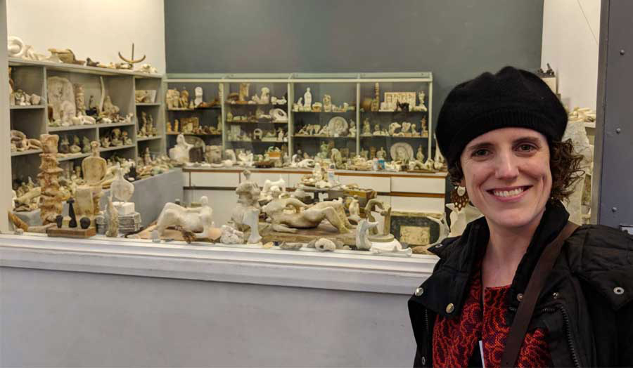 Helena selfie with sculpture collection behind