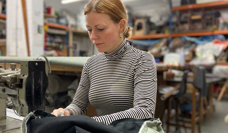 Charlotte Ferreira working in the studio with a sewing machine