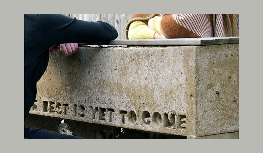 Arms of two people resting on solid concrete that read...the best is yet to come