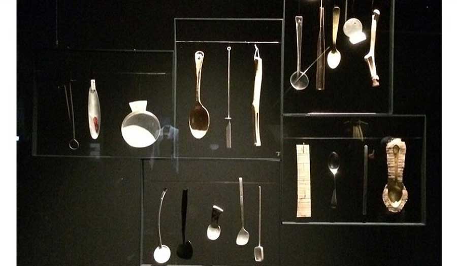 A display of hanging spoons and other utensils.
