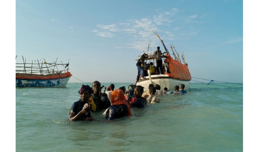 People in a boat and in water