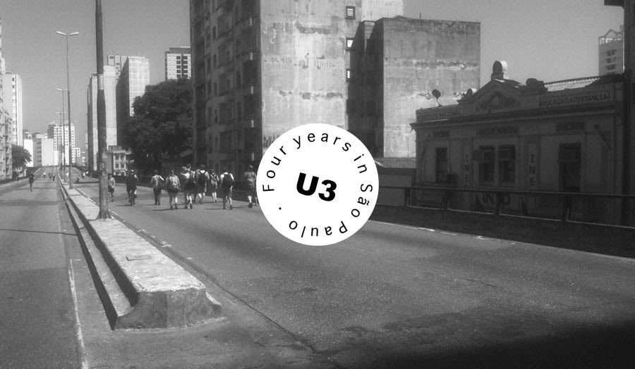 Black and white photo of people walking through an urban setting