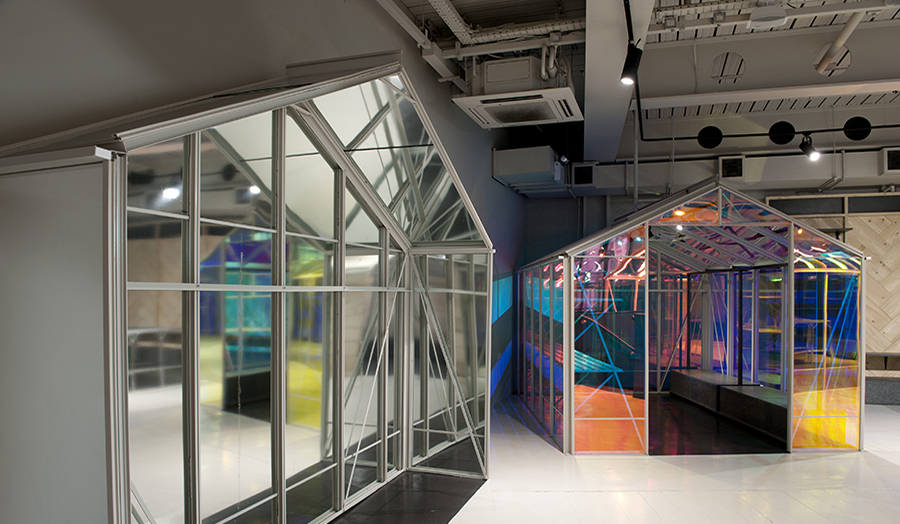 Image of two shed-like structures inside a warehouse