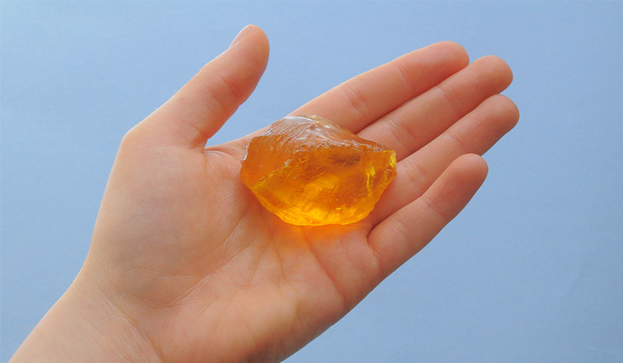 Hand holding jelly or a gem stone
