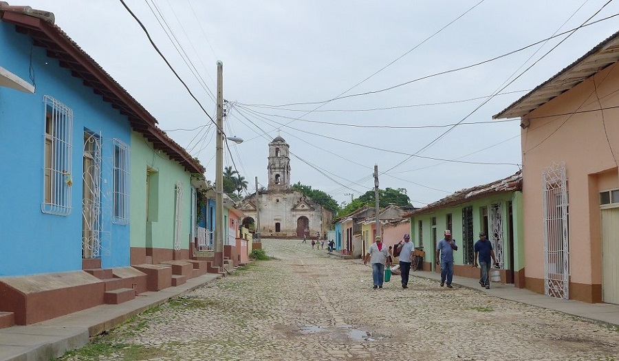 A photograph of a street lined with houses in Cuba