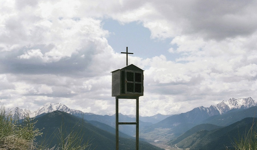 A photograph from the Territorial exhibition of a wooden structure in the mountains