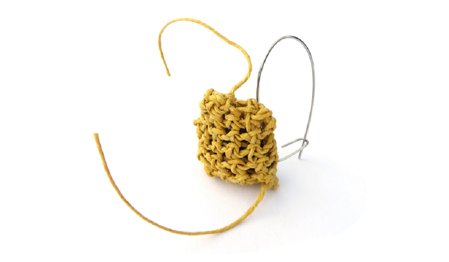 image of yellow pin made with metal and twine
