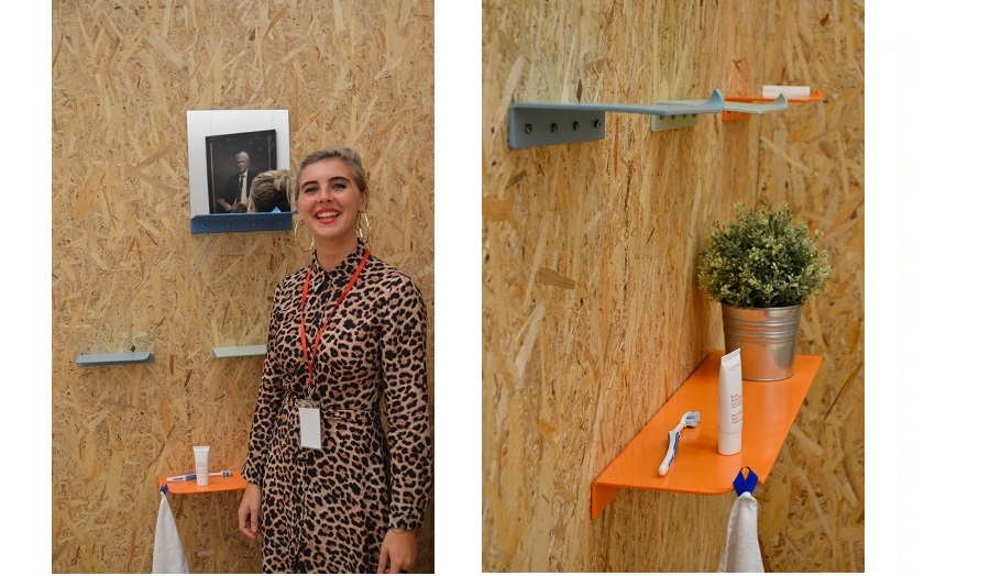 woman stand next to shelving mounted on chipboard wall 