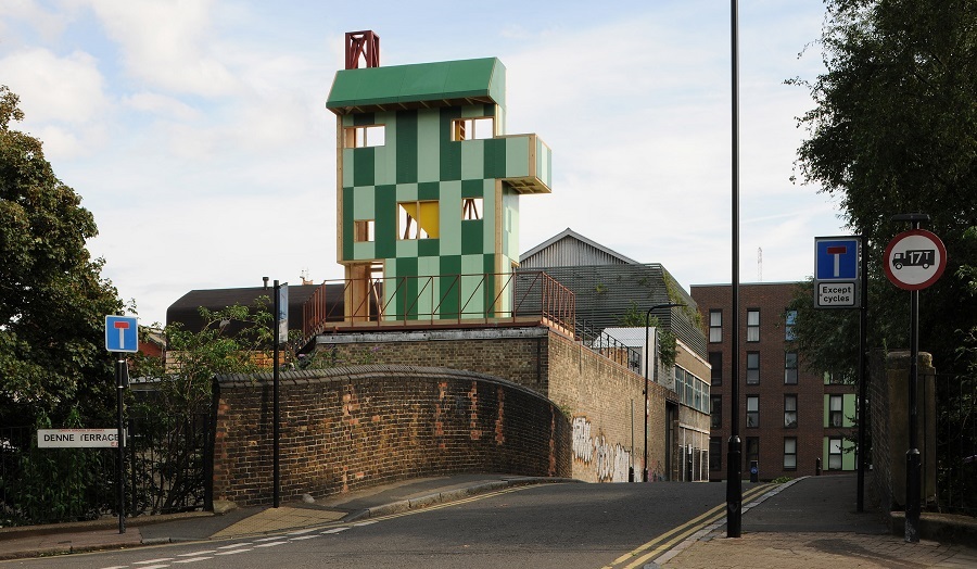 Green three storey structure on top of urban building