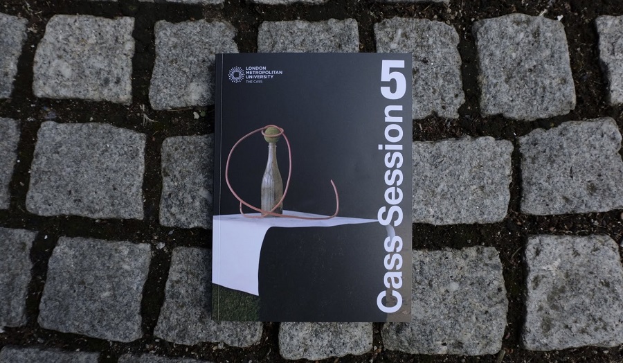 a book lying on a exterior cobbled floor