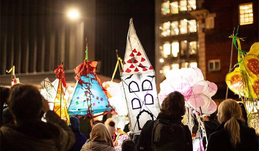 People holding lanterns in a parade