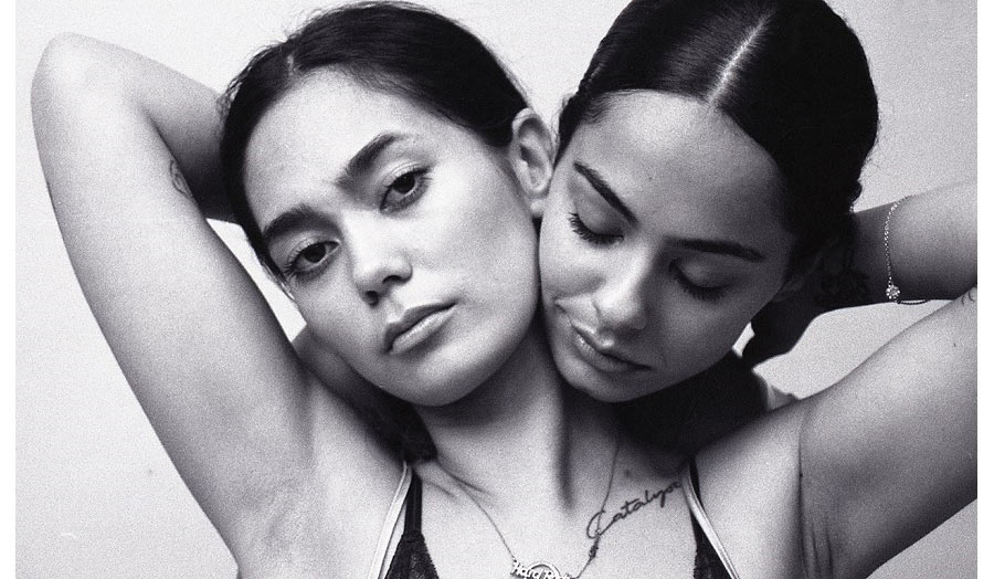 Fashion photography, two models embraced by the neck