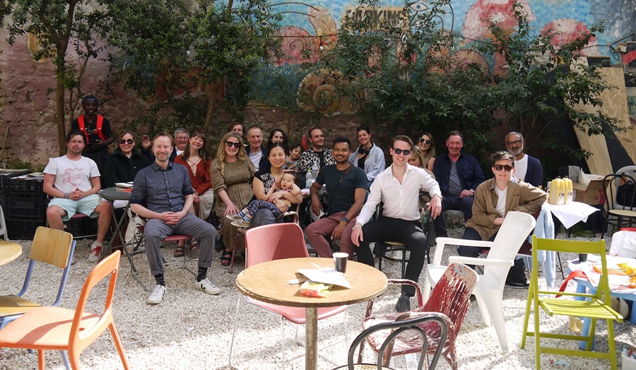 A group of people sit outside in the sun