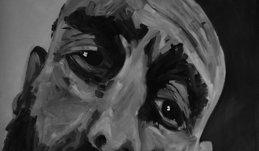 Black and white painted close up of mans face showing eyes and nose