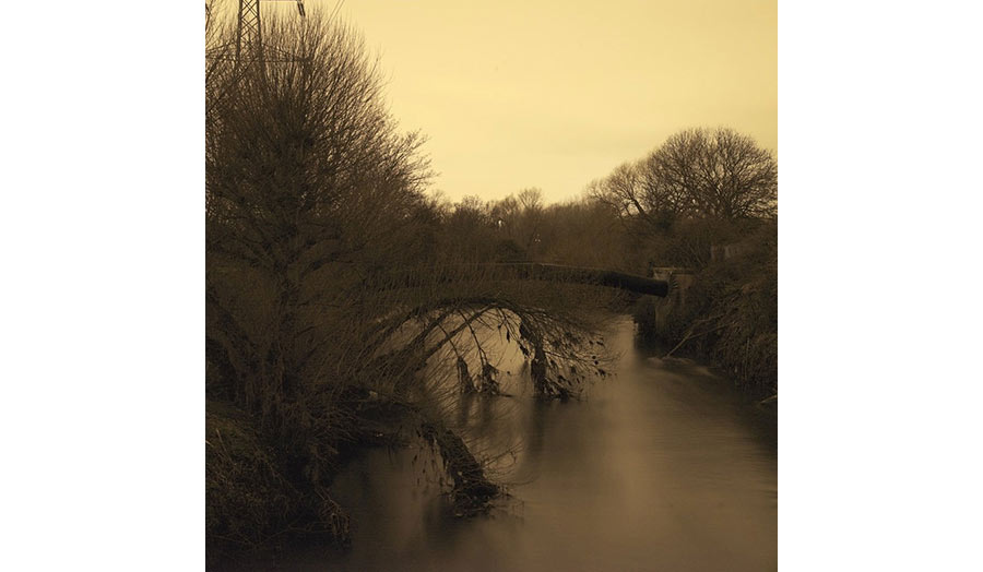 View of a river going under a pipe line