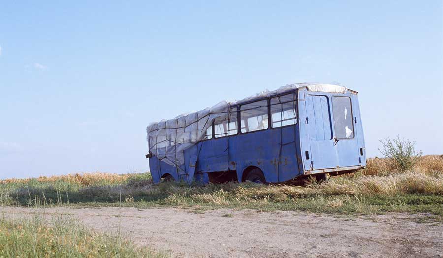 Abandoned bus on the Serbia-Romania border in Borderlands by Paola Leonardi