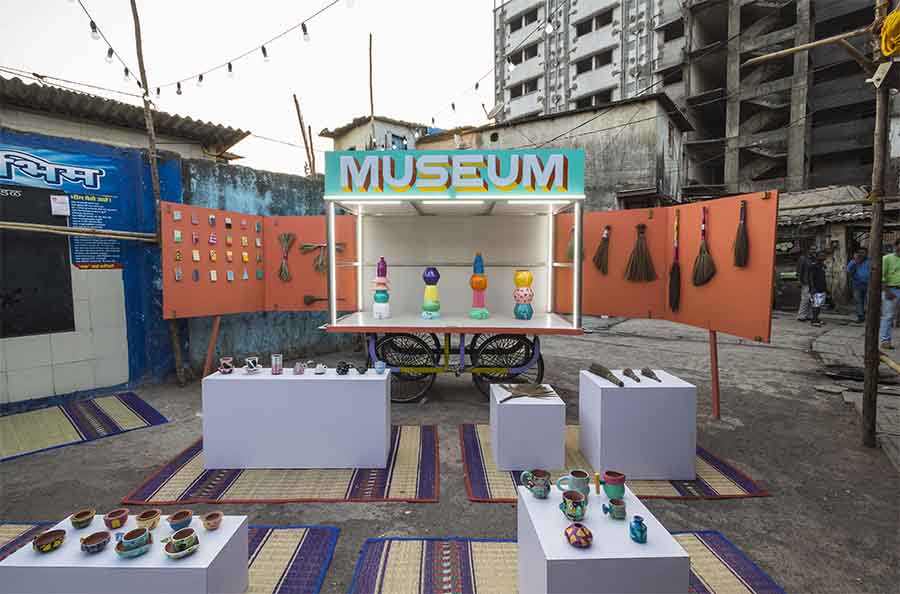 Display of colorful pots and rugs in a mobile museum