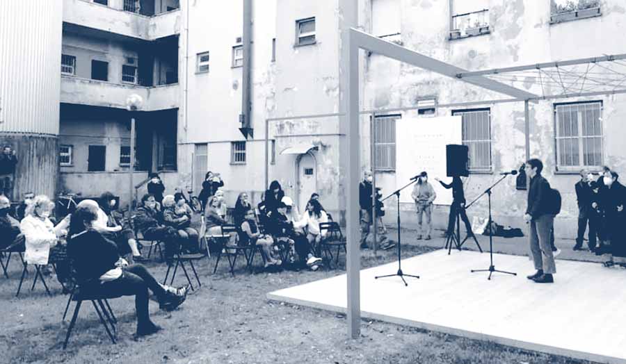 People sat outside listening to a lecture