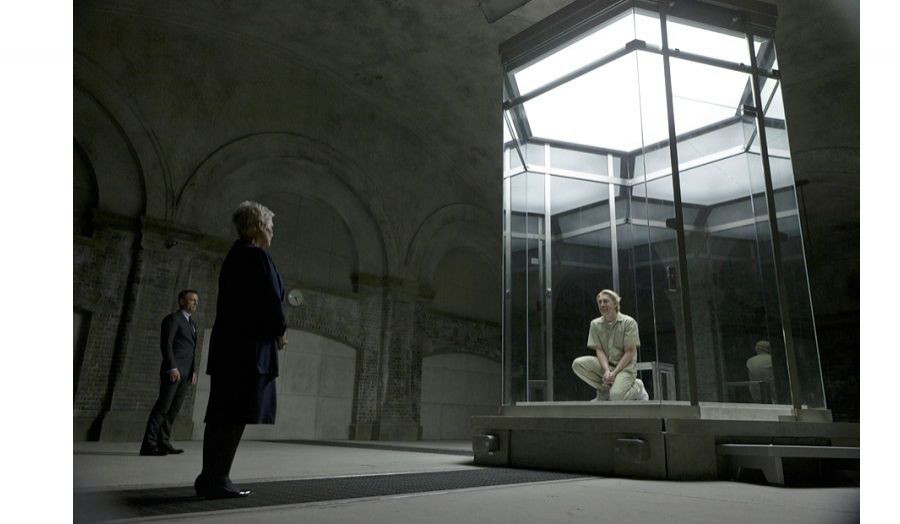 Still from Skyfall film, showing dark cellar area with skylight flooding light in from above