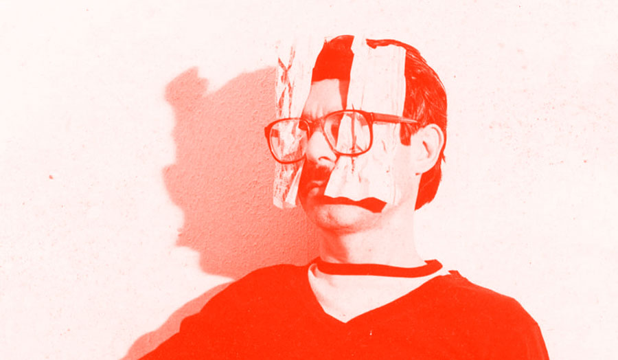 Two-tone self portrait of Ulises Carrión with partial shadow, showing paper underneath his glasses