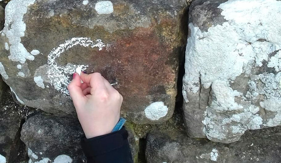 Hand drawing with chalk on rocks