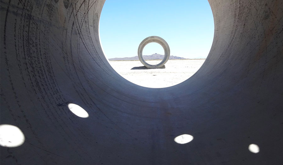 Nancy Holt, Sun Tunnels, A view through concrete pipes, sun, sand