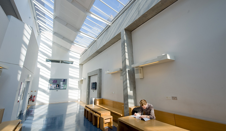 Male student studying in Goulston Street Atrium, Calcutta House