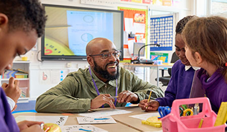 Female teacher talking to a student in class