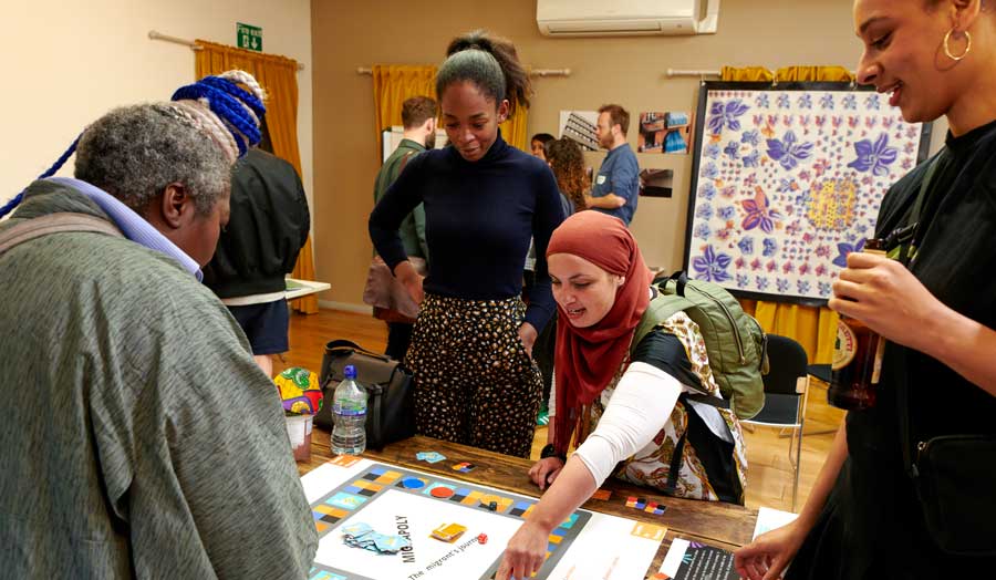 a group of students playing a handmade board game