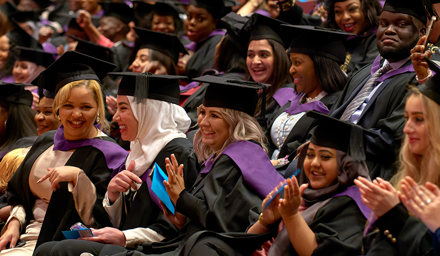 Group of students clapping at London Met graduation ceremony in 2022
