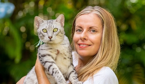 Carla Francis holding a cat looking at the camera