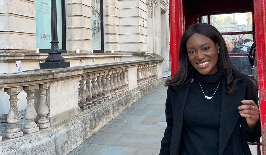 USA student Anthea Ojadi posing outside a red British phonebox