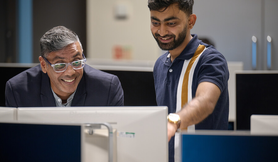 Students showcasing his work to a lecturer